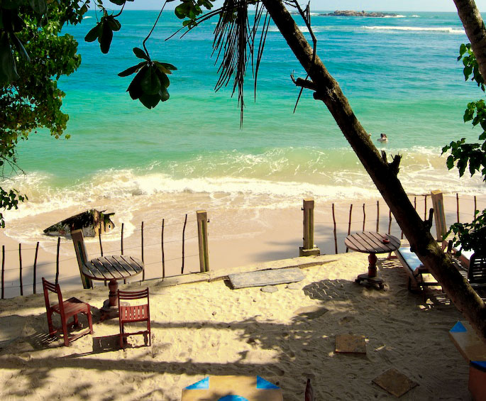 Mannar Beach Sri Lanka - endless golden sands with rustic fishing boats under dramatic skies
